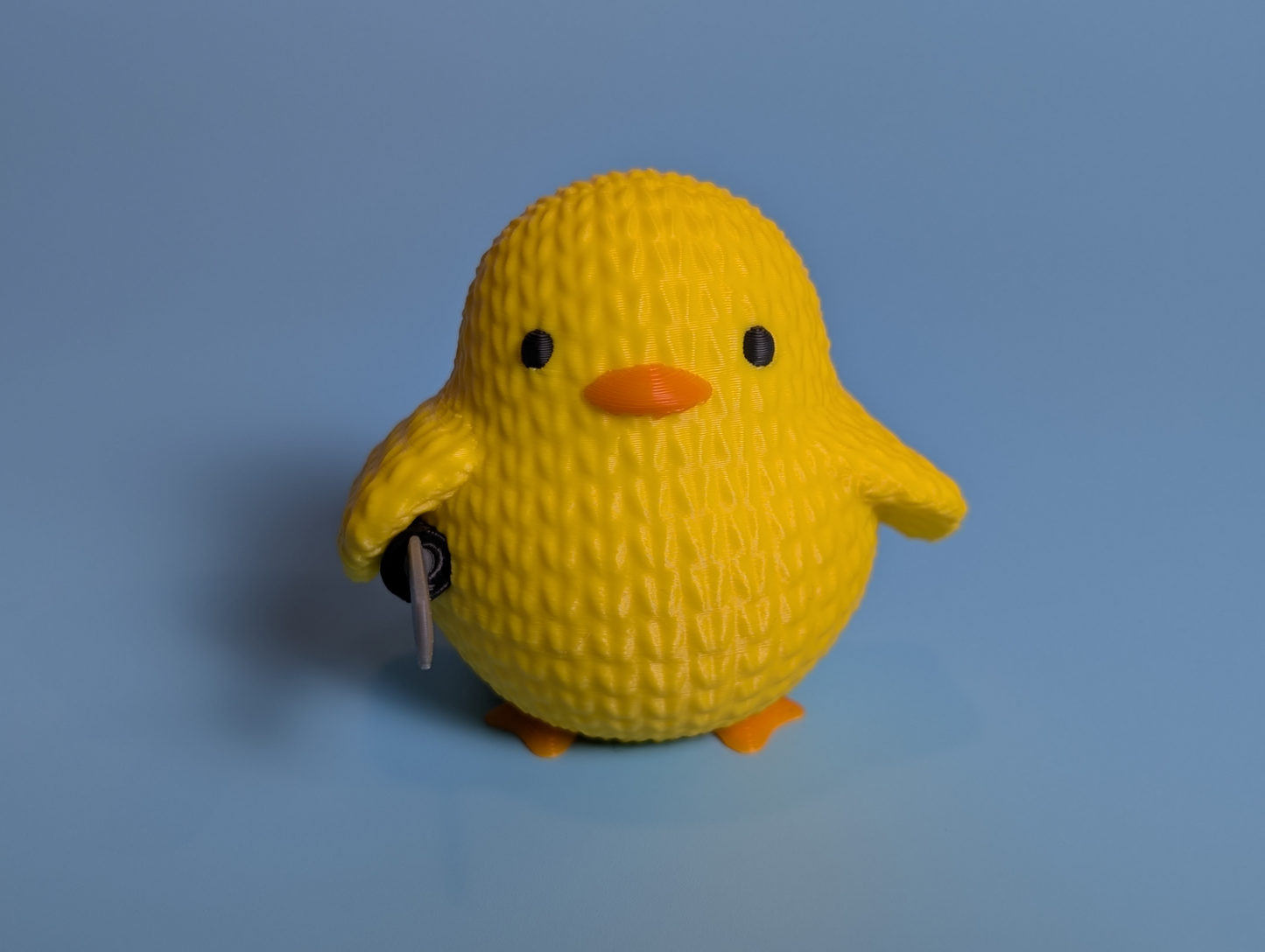 Knitted duck with a knife action figure